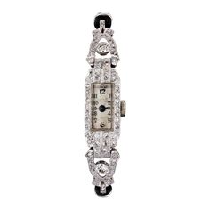 Rectangular, this art deco watch features geometric lines and decorations set with diamonds. The bracelet is a double black cord retained by white gold ties. The white gold clasp is a folding clasp with ratchet and adjustment. The dial is light gray. Mechanical watch with manual winding. Numbered on the back of the case. Height of the dial: 1.8 cm, width of the dial: 0.6 cm, total length of the pattern: 6 cm, width: 1 cm. Total weight of the jewel: approximately 15 g. Revised and repolished watc Luxury Art Deco Jewelry And Watches For Formal Occasions, Art Deco Watch Women, Art Deco Rectangular Watch With Diamond Markers, Art Deco Rectangular Watch With Diamond Hour Markers, Art Deco Platinum Evening Watches, Platinum Art Deco Evening Watches, Evening Diamond Watch With Art Deco Style, Art Deco White Gold Diamond Watch, Evening Art Deco Diamond Watch With Accents