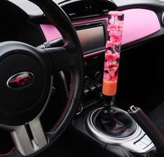 a pink and black car dashboard with flowers on it