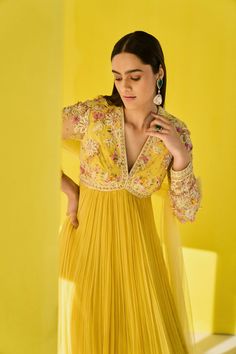 Editor's Note Radiate joy and charm in our yellow chiffon multi-colored embroidered net full-length anarkali. Adorned with vibrant embroidery, it exudes a festive vibe. Paired with an embroidered net dupatta featuring organza frills, this ensemble is a perfect choice for celebratory occasions. Step into the spotlight with this vibrant and elegant outfit. Fabric: Anarkali: net/chiffon, dupatta: net/organza Color: Yellow Components: Anarkali and dupatta Occasion: Festive and haldi mehndi Note: Pro Yellow Anarkali, Ridhi Mehra, Long Anarkali, Anarkali Dress Pattern, Embroidered Crop Tops, Dress Indian Style, Dusky Pink, Net Dupatta, Anarkali Dress