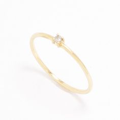 a yellow gold ring with a single diamond