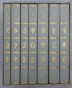 six books with gold designs on them