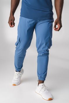 How does the piece fit? Classic, athletic jogger fit Ruched waistband with branded interior drawstring for customization for your body Features a lightweight performance liner and mesh ventilation to allow air flow Designed with utility style cargo pockets and hidden zip pockets to ensure no belongings fall out, without extra bulk Elastic ankle cuffs with side zip detail for comfort and style aesthetic What is the fabric made for and how does it feel? Engineered for performance, comfort, and sty Utility Style, Body Features, Flow Design, Style Cargo, Cargo Joggers, Style Aesthetic, Ankle Cuffs, Mens Bottom, Parachute Pants