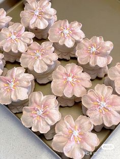 there are many cupcakes that have pink flowers on them in the shape of flowers