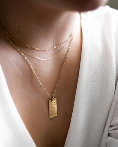 "This vertical bar necklace is a classic, easy to gift piece. From the chain to the pendant, this style is made with 14k gold filled or sterling silver pieces, meaning it is built to last. Personalize this necklace with the names, dates, and special words that mean the most to you! 𝗘𝗮𝘀𝘆 𝗧𝗼 𝗦𝘁𝘆𝗹𝗲, 𝗠𝗮𝗱𝗲 𝗧𝗼 𝗟𝗮𝘀𝘁 Our delicate vertical bar necklaces are elegant, perfect for layering, ready to be personalized with your most special sentiments, moments, and memories! Created to las Dainty Rectangular Pendant Bar Necklace For Everyday, Gold Bar Necklace With Rectangular Pendant For Everyday, Dainty Gold Bar Necklace With Rectangular Pendant, Elegant Everyday Bar Necklace For Mother's Day, Gold Engraved Bar Necklace For Everyday, Personalized Gold Bar Necklace For Everyday, Everyday Personalized Gold Bar Necklace, Name Tag Necklace, Necklace With Kids Names