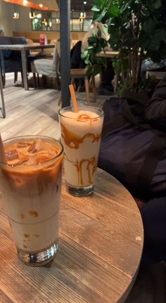 two drinks sitting on top of a wooden table