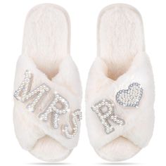 a pair of white slippers with the word love written on it and two hearts