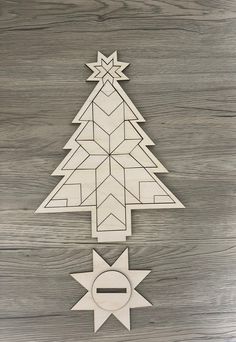 a wooden cutout of a christmas tree with an ornament in the middle