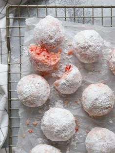 powdered sugar covered pastries on a cooling rack