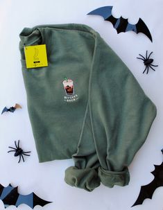 - SWEATSHIRT DETAILS -  'Tis the season for Pumpkin Spice & coffee for cool morning walks! Cozy up with a PSL and our Witches Brew Fall embroidered sweatshirt to put you in the Halloween spirit. Our original Witches Brew Pumpkin Spice Cold Brew design has been embroidered on a heavy blend crewneck sweatshirt. This design is available in 3 Halloween festive colors: Military Green, Black, and Bright Orange.  This product is made from our original artwork and embroidered locally in Dallas, TX. 50% Fall Sweatshirt With Embroidered Logo For Loungewear, Fall Sweater With Embroidered Logo For Loungewear, Casual Tops With Embroidered Logo For Fall, Trendy Custom Embroidered Winter Sweatshirt, Trendy Tops With Custom Embroidery For Fall, Casual Loungewear Tops With Custom Embroidery, Fall Custom Embroidered Sweater For Streetwear, Custom Embroidered Sweater For Fall Streetwear, Custom Embroidery Sweater For Fall Streetwear