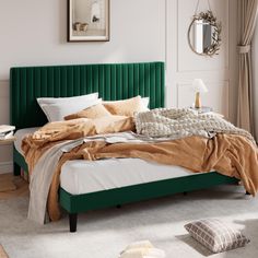 a bedroom with a green headboard and white walls