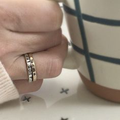 Add a touch of individuality to your jewelry collection with the Typewriter Name Ring from Going Golden. Handcrafted in Brownsburg, Indiana, this ring is perfect for those who love a classic, typewriter-style font. Available in 14K gold-filled, fine silver, or rose gold, this ring offers 100x more solid gold than plated alternatives, ensuring it’s waterproof and tarnish-resistant. Each ring comes with a polishing pad and a gift box, making it a thoughtful gift for someone special or a delightful Hand Stamped 14k Yellow Gold Engraved Ring, 14k Yellow Gold Hand Stamped Engraved Ring, 14k Yellow Gold Engraved Ring With Hand Stamped Details, Heirloom Style Gold Stackable Sterling Silver Rings, Heirloom Gold-toned Sterling Silver Stackable Rings, Heirloom Gold-colored Sterling Silver Stackable Rings, Heirloom Rose Gold Stackable Rings Stamped 14k, Tarnish Resistant Brass Rings For Anniversary, Gold Engraved Brass Ring Gift