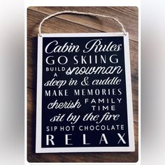 a sign that says cabin rules go skiing and sleep in & cuddle make memories cherish time sit by the fire sip hot chocolate