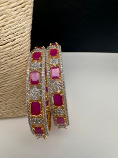 Ameriacan Diamond Ruby Red Bangles. It comes as a Pair (2 Bangles). Premium quality and craftmanship. Satisfaction Guaranteed. Please measure your size before ordering as we don't accept returns. Starting size we have is 2.4. We don't carry size 2.2. Red Round Bangle For Party, Red Bangle For Jewelry Making, Red Ruby Bangle As Gift, Red Hand Set Bangle For Party, Red Ruby Bangle For Wedding, Handmade Red Ruby Bracelets, Red Ruby Bracelet For Festive Occasions, Festive Red Ruby Bangle, Elegant Handmade Red Bangle