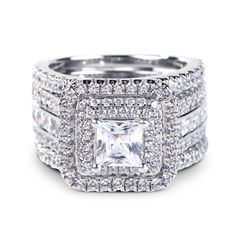 an engagement ring set with two rows of diamonds on each band and a princess cut diamond in the center