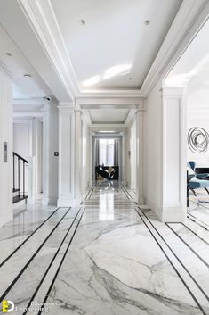 an elegant hallway with marble floors and white walls