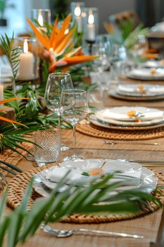 the table is set with place settings and candles