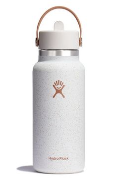 the hydro flask water bottle is white and has a brown handle on it's side