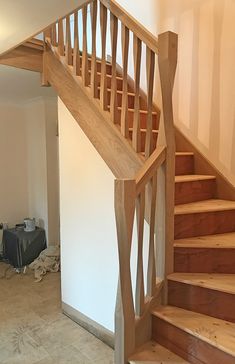 an empty living room with stairs leading up to the second floor