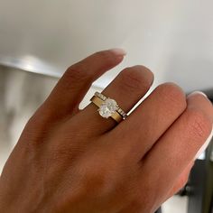 a woman's hand with a diamond ring on it