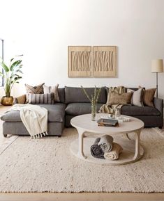 a living room filled with furniture and a rug on top of a white carpeted floor