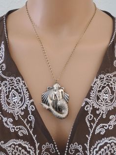 "Vintage Jewelry - Mermaid Jewelry - Mermaid Necklace - Statement Necklace - Beach Necklace - Vintage Brass - Vintage Necklace- handmade This is such an awesome beachy statement necklace! A large beautiful mermaid hangs in front of a shell. Bold and beautiful. The pendant hangs from a pretty vintage ladder chain. USA vintage brass. Chloe says, \"Wear it and feel fabulous!\" The pendant is 2 1/4\" long. You can choose the necklace length you would like at checkout. Thank you for visiting Chloe's" Bohemian Mermaid Necklace For Gifts, Bohemian Mermaid Necklace Gift, Bead Bugs, Tropical Necklace, Vintage Ladder, Mermaid Jewelry, Vintage Jewelry Art, French Jewelry, Beach Necklaces