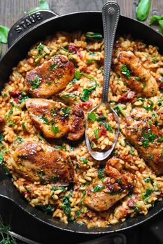 a skillet filled with chicken and rice