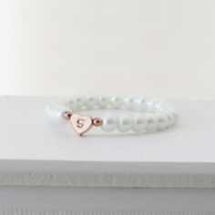 Children's Initial and Heart Bracelet Flower Girl Gift Kids Jewelry Wedding Gift for Kids Flower girl Proposal Baby Child Infant Bracelet This adorable bracelet features a row of faux glass pearls with an adorable heart charm hand stamped with a letter of your choice. Choose from ivory or white pearls , silver, rose gold or gold heart charm and font style. How to order -Select pearl colour and size from the drop down menu - Select you heart colour and font option from the drop down menu -add in Elegant Beaded Bracelet With Heart Charm For Wedding, Elegant White Heart Bracelet For Wedding, White Hypoallergenic Bracelets For Wedding, Elegant Wedding Beaded Bracelet With Heart Charm, Dainty Heart Bracelet For Valentine's Day Wedding, Elegant Heart Beads Charm Bracelet For Wedding, Adjustable Heart Bracelet For Weddings, Elegant Adjustable Heart Bracelet For Birthday, Dainty Heart Bracelet For Wedding And Valentine's Day