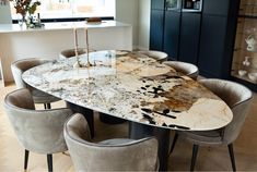 a marble dining table with chairs around it