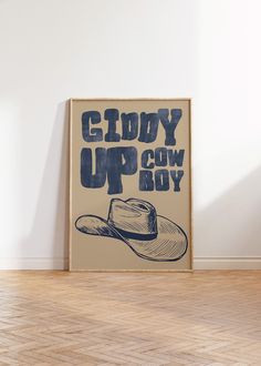 a cowboy hat sits on the floor in front of a poster that says glory up cow boy