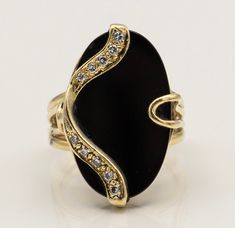 "\"Oval Onyx Splendor 14K Gold Estate Ring with 10 Diamonds\" Description: Presenting the \"Oval Onyx Splendor 14K Gold Estate Ring,\" a one-of-a-kind masterpiece that combines the timeless beauty of onyx with the brilliance of diamonds. This custom-made ring is a true testament to elegance and individuality. Key Features: 1. Stunning Onyx Centerpiece: At the heart of this exquisite ring lies a captivating oval onyx gemstone, exuding an aura of mystique and sophistication. Its deep, lustrous bla Oval Jewelry With Polished Finish For Evening, Exquisite Oval Jewelry For Evening, Fine Jewelry Oval Evening Jewelry, Exquisite Oval Rings For Evening, Oval Stone Setting Jewelry For Formal Occasions, Oval Yellow Gold Ring With Stone Setting, Yellow Gold Oval Rings With Stone Setting, Heirloom Oval Jewelry With Stone Setting, Exquisite Oval Stone Setting Rings