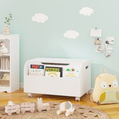 a child's room with blue walls and white furniture, including a bookcase