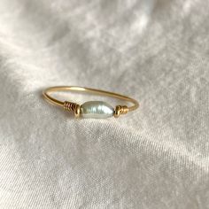 This beautifully simple ring is lovingly handmade with tiny Baroque Freshwater Pearl and a choice of 14k Gold Filled, 14k Rose Gold Filled or Sterling Silver band. M A T E R I A L S: * Freshwater Pearl * 14k Gold Filled, 14k Rose Gold Filled or Sterling Silver S I Z E: *  Gemstone - Approximately 2mm each *  Band Thickness - Approximately 0.8-1mm  All of our jewellery is carefully handmade using good quality materials and handpicked gemstones, with the aim to produce quality pieces that you can Dainty Hand Forged Gold Stackable Rings, Dainty Hand Forged Rings For Everyday, Dainty Hand-forged Rings In Recycled Gold, Hand Forged Dainty Rings In Recycled Gold, Hand Forged Recycled Gold Dainty Rings, Dainty Hand Forged Yellow Gold Rings, Handmade Gold Minimalist Pearl Ring, Adjustable Stackable Pearl Ring In Fine Jewelry Style, Handmade Minimalist Gold Pearl Ring