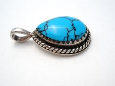 Southwestern Jewelry - This is a sterling silver pendant with a pear shaped turquoise gemstone with black matrix. It is hallmarked 925 with maker's mark, weighs 4.5 grams and measures 1.1" (29mm) long and .63" (16mm). Blue Turquoise Necklace With Large Teardrop Stone, Turquoise Teardrop Necklace With Large Stone, Southwestern Jewelry, Maker's Mark, Turquoise Gemstone, Blue Turquoise, Turquoise Sterling Silver, Sterling Silver Pendant, Turquoise Blue