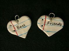 two ceramic heart shaped key chains with the words best and friends written on each one