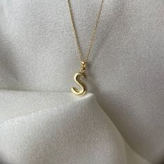 Make a statement with this custom initial letter necklace, crafted from high-quality 14K gold. Show off your personal style with a unique pendant, designed in the shape of a tiny balloon, featuring any letter of the alphabet that you choose. This necklace makes the perfect gift for any occasion, such as Valentine's Day, an anniversary, or just as a thoughtful surprise for that special someone in your life.  The necklace comes with a dainty chain and is perfect for layering with other necklaces, Tan Monogram Initial Pendant Necklace, Tan Initial Pendant Necklace, Tan Initial Pendant Charm Necklaces, Classic Tan Initial Pendant Necklace, Tan Initial Pendant Charm Necklace, Everyday Tan Necklaces With Initials, Initial Pendant Necklace With Name, Yellow Gold Monogram Initial Necklace, Tan 14k Gold Necklaces With Initials