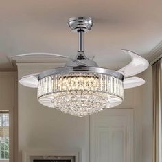 a chrome ceiling fan with crystal chandelier hanging from it's center point