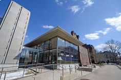 a large building with stairs leading up to it's entrance and windows on the side