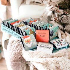 many small bags are stacked on top of each other in front of a white chair