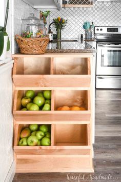 an open kitchen cabinet filled with apples and oranges