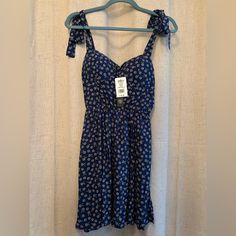 As U Wish Junior Size M Mini Sundress. Upper Inside Padding. Full Straps With Separate Ties At The Top And Buttons In The Back. Elasticized Upper Back. Color: Nabll. Lavender Flower Design On Navy Blue With Green Leaves. Nwt. Pairs Well With Sandals, Flats, Heels Or White Tennies. Approximate Length, 26” Blue Sundress With Adjustable Straps, Mini Length, Purple V-neck Sundress For Summer, Purple V-neck Sundress, Indigo V-neck Summer Dress, Blue Floral Print Mini Sleeveless Dress, Sandals Flats, Lavender Flower, Mini Sundress, Floral Sundress