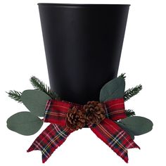 a christmas decoration with pine cones and plaid ribbon on a black cup, isolated against a white background