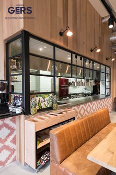 the inside of a restaurant with wooden tables and benches