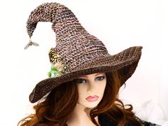 Ready for the Renfaire, a Steampunk festival, cosplay, a witch gathering, your table centerpiece, or just plain fun, this witch hat is firmly structured but soft to wear. Ready to navigate the forest or the sea, I've done this one with a bit of mariner steampunk and just a touch of forest. A steampunk style firefly dangles from the tip to light your way in the dark, with an octopus wrapped around an anchor at the base, and some ferns and feathers tucked behind. The way I stitch allows you to twist and shape or return it to straight up. The wired brim can also be shaped in any number of ways. When you're not wearing it, you can toss it on your table for a great conversational centerpiece, or hang it on a hook by the door! Folds flat for your travels. -This soft witchy hat has some stretch s Witchy Hats For Halloween, Witchy Halloween Hat, Halloween Costume Mini Cap, Steampunk Hat And Headpieces For Halloween, Steampunk Costume Hats And Headpieces For Halloween, Gothic Wide Brim Costume Hat For Festivals, Brown Costume Hats And Headpieces For Halloween, Gothic Wide Brim Festival Costume Hat, Bohemian Cap Costume Hats And Headpieces For Party