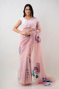 A hand-painted soft organza pink saree is a work of art that combines elegance and beauty with unparalleled creativity and quality. Handmade by skilled artisans, this saree is a testament to the traditional Indian craftsmanship that has been passed down through generations. The soft organza fabric is a sheer, lightweight material that drapes beautifully, creating a flattering silhouette. The gentle pink color of the saree is perfect for a variety of occasions, including weddings, parties, and formal events. What sets this saree apart is its unique hand-painted design. Each saree is meticulously painted by hand, creating a one-of-a-kind masterpiece that is sure to turn heads. The painter takes great care in selecting the colors and patterns that will adorn the saree, ensuring that every det Pink Fitted Pre-draped Organza Saree, Pink Chanderi Pre-draped Saree With Sheer Dupatta, Pink Organza Sets With Unstitched Blouse, Pink Organza Pre-draped Saree For Party, Pink Organza Pre-draped Saree For Celebration, Fitted Pink Organza Traditional Wear, Pink Tissue Silk Saree Set, Pink Pre-draped Organza Saree With Pallu, Pink Chanderi Pre-draped Saree For Celebration