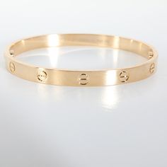 Cartier Love Bracelet in 18k Yellow Gold  PRIMARY DETAILS  SKU: 140159  Listing Title: Cartier Love Bracelet in 18k Yellow Gold  Condition Description: Cartier's Love collection is the epitome of iconic, from the recognizable designs to the history behind the line-up. The collection started in 1969 with the bangle bracelet, which is engraved with a circular motif throughout to mimic the look of the bracelet's signature screw-lock mechanism.     Retails for 7350 USD. In excellent condition and recently polished. Comes with papers.  Brand: Cartier  Collection/Series: Love  Metal Type: Yellow Gold  Metal Purity: 18k  Chain or Bracelet Length (in): 18  Pre-Owned Jewelry Condition: Excellent  SIDE STONE INFORMATION  Original Box?: No  Original Papers?: No  This item has been used and may have s Carter Bracelet, Cartier Love Collection, Cartier Collection, Jewelry Cartier, Modern Bangle, 18k Gold Bangle, Contemporary Bracelets, Plastic Bangles, Cartier Bracelet