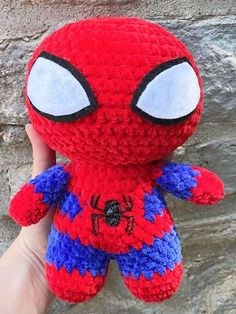 someone is holding up a crocheted spider - man stuffed animal that looks like it has big eyes