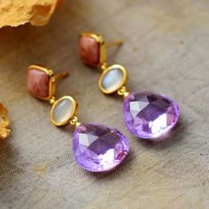 This exquisite Luxury Teardrop Earring is the perfect adornment for any sophisticated ensemble. Handcrafted with an exquisite gemstone, this luxurious piece of jewelry will both captivate and mesmerize its beholder. A timeless addition to any jewelry collection, the Luxury Teardrop Earring is the definition of elegance. Material: Amethyst Plating: Gold-plating Size: Around 4 cm Product condition: 100% New and Exquisite Quality. Returns: Money back guarantee (30 days free return) About Shipping: Luxury Drop Earrings With Natural Stones, Luxury Natural Stone Drop Earrings, Luxury Amethyst Teardrop Earrings, Elegant Gold Teardrop Earrings With Gemstone, Elegant Amethyst Teardrop Dangle Earrings, Elegant Gemstone Teardrop Earrings For Anniversary, Exquisite Gemstone Drop Earrings, Elegant Drop Crystal Earrings For Gift, Elegant Briolette Crystal Earrings Gift