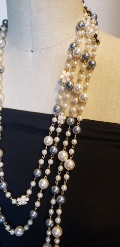 Description: Inspired to accessorize that black dress worn by Audrey Hepburn in Breakfast at Tiffany's, this beautiful extra long Vintage style Multi strand faux pearl necklace is sure to garner attention and turn heads! Really adds flare to that 'little Black Dress" This is a Chandra's Treasures original piece. I use beautiful lustrous imitation pearls for this piece with double sided black and white floral motifs containing a small faux pearl centerpiece. There are many ways to wear this neckl Luxury Double Strand Necklaces For Formal Occasions, Cheap Statement Long Chain Necklace, Luxury Double Strand Necklace For Party, Affordable Statement Long Necklace For Party, Cheap Statement Long Necklace For Party, Luxury Formal Necklaces With Pearl Embellishments, Luxury Vintage Pearl Necklace For Evening, Luxury Glamorous Pearl Necklace With Pearl Chain, Luxury Statement Drop Necklace For Women