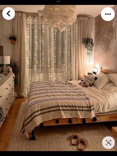 a bed room with a neatly made bed and lights