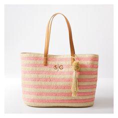 Take summery nautical style wherever your roam with this roomy straw bag. Designed for all your essentials for sunbathing on the sand or lazing by the lake, this sophisticated tote is equally at home in town as an everyday carryall. Crocheted from alternating colors of paper straw for a striped design, with a pom pom tassel and vegan leather handles for comfortable toting. Add a custom monogram to make it your own.    21"w x 6"d x 13"h  Handle drop: 9.5"  100% paper; vegan leather (polyurethane) Beachy Sand-colored Straw Bag, Chic Sand-colored Straw Tote Bag, Straw Beach Bag In Sand Color For Vacation, Summer Jute Beach Bag In Sand Color, Sand-colored Straw Beach Bag For Vacation, Vacation Straw Beach Bag In Sand Color, Summer Sand-colored Straw Bucket Bag, Vacation Beach Bag In Sand Color Made Of Straw, Beige Straw Bag For Everyday Beachwear